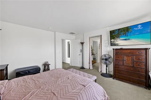 a bedroom with a bed and a television