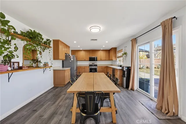 a large kitchen with a table and chairs