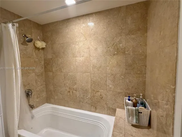 a bathroom with a bathtub and shower