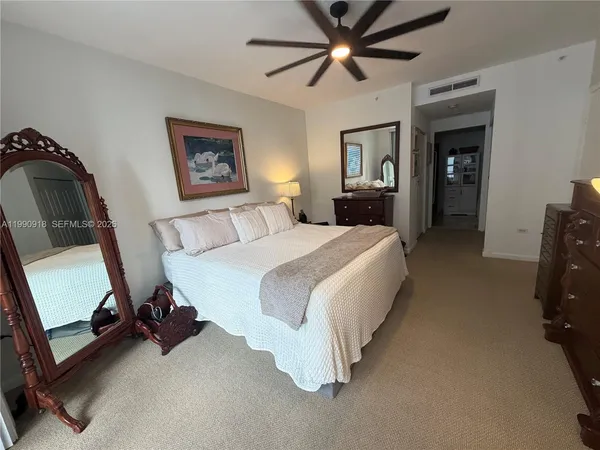 a bedroom with bed and a chandelier