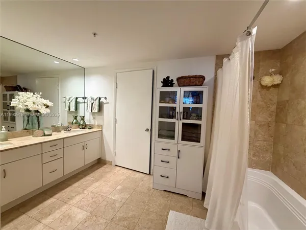 a spacious bathroom with a shower and a sink