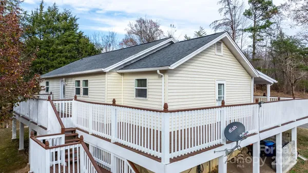a view of a house with a deck and a yard