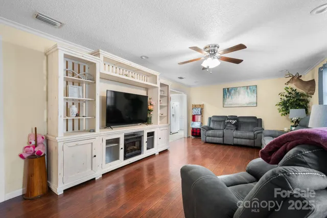 a living room with furniture flat screen tv and a fireplace