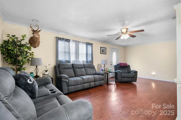 a living room with furniture and a chandelier