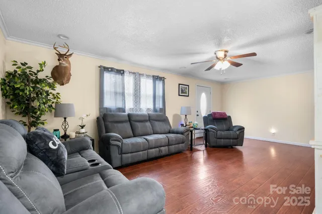 a living room with furniture and a chandelier