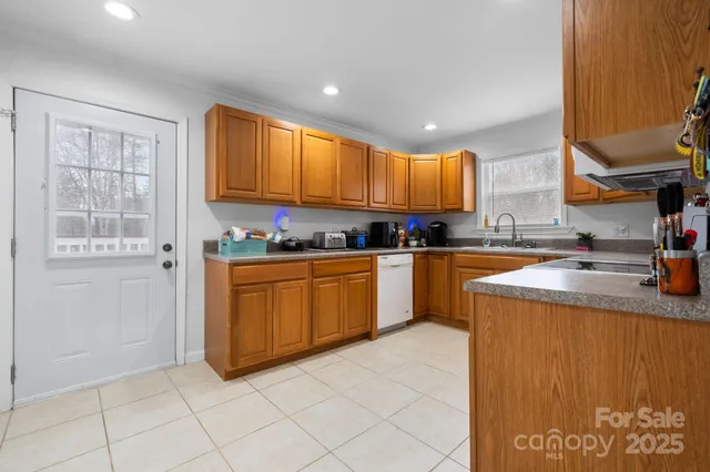 a kitchen with stainless steel appliances granite countertop a stove sink and cabinets