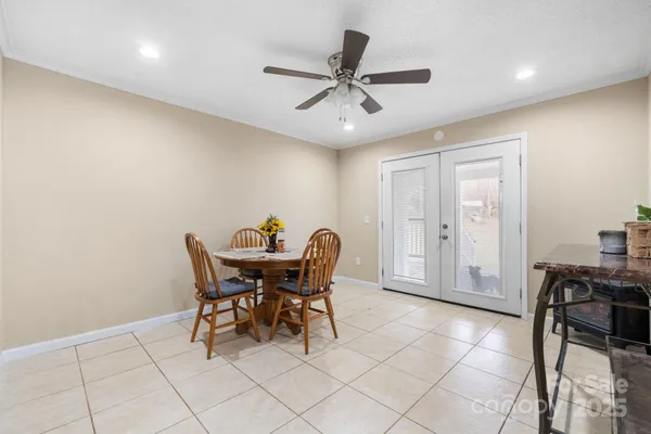 a view of a dining room with furniture and a chandelier fan