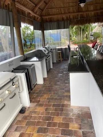 a kitchen with stainless steel appliances a stove a sink and a refrigerator