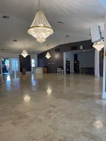 a living room with furniture pool table and window