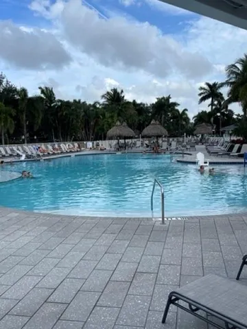 a view of house with roof deck and seating space