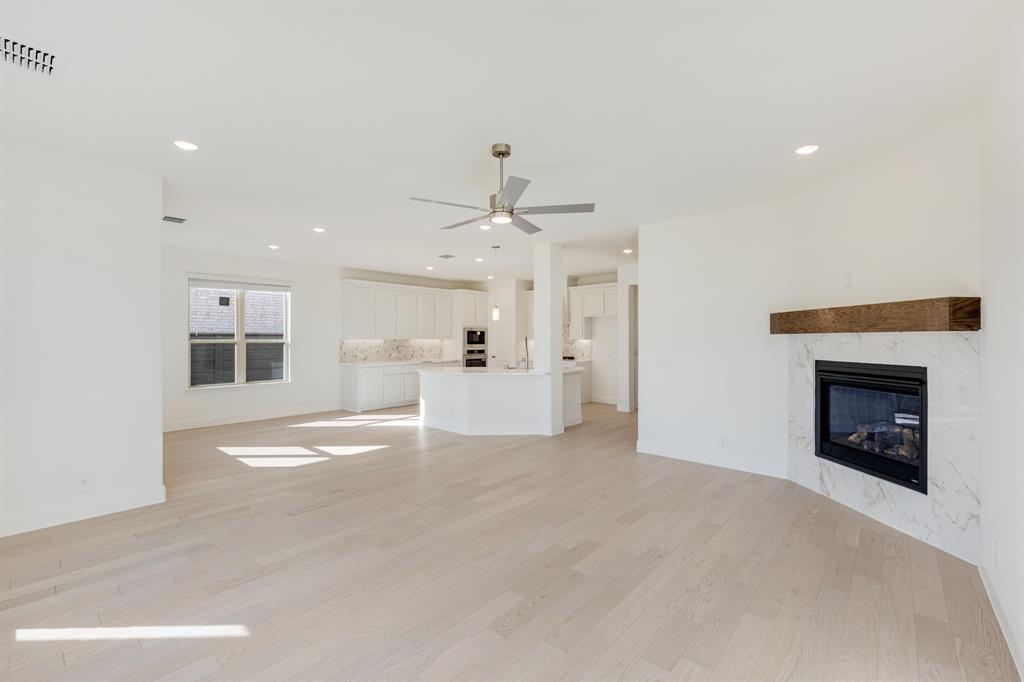 7308 Iris Road Aubrey, TX 76227 - Photo 16 of 40 a view of a kitchen and an empty room