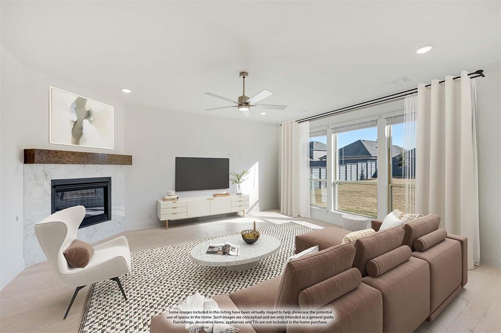 7308 Iris Road Aubrey, TX 76227 - Photo 17 of 40 a living room with furniture and a flat screen tv