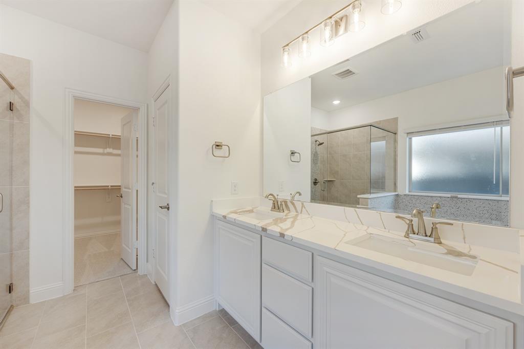 7308 Iris Road Aubrey, TX 76227 - Photo 21 of 40 a bathroom with a sink and a mirror