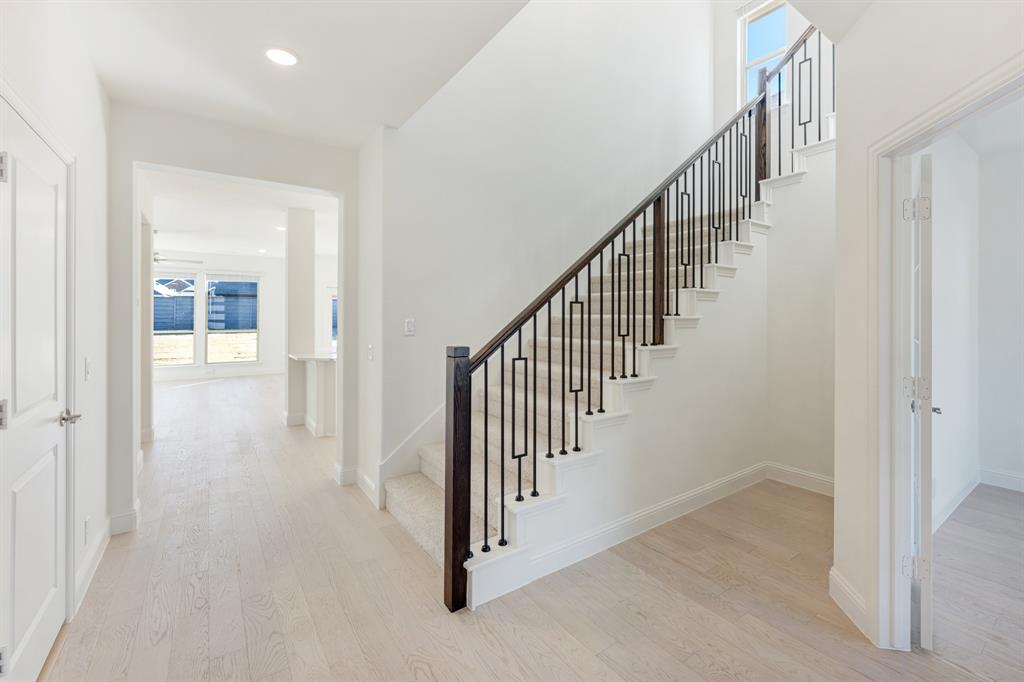 7308 Iris Road Aubrey, TX 76227 - Photo 23 of 40 a view of a hallway with staircase