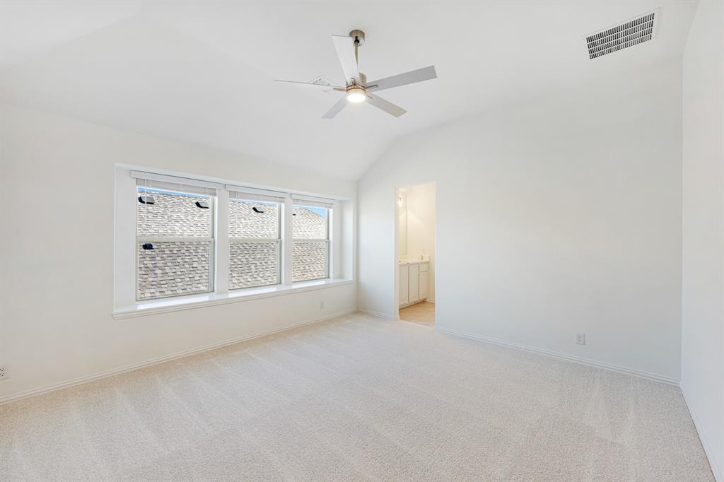 7308 Iris Road Aubrey, TX 76227 - Photo 27 of 40 an empty room with a ceiling fan and windows