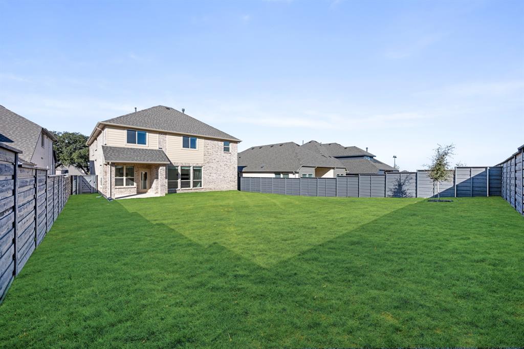 7308 Iris Road Aubrey, TX 76227 - Photo 39 of 40 a view of a big house with a big yard and large trees