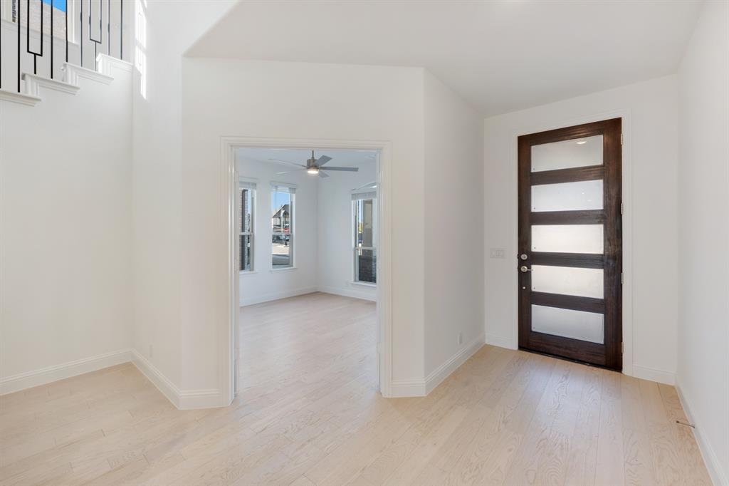 7308 Iris Road Aubrey, TX 76227 - Photo 5 of 40 an empty room with windows and closet