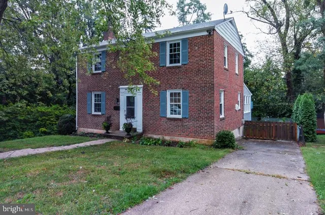 a view of a brick house with a yard