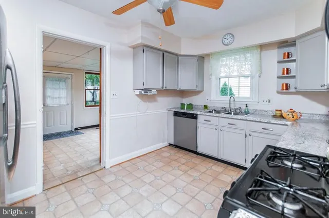 a kitchen with a sink appliances and cabinets