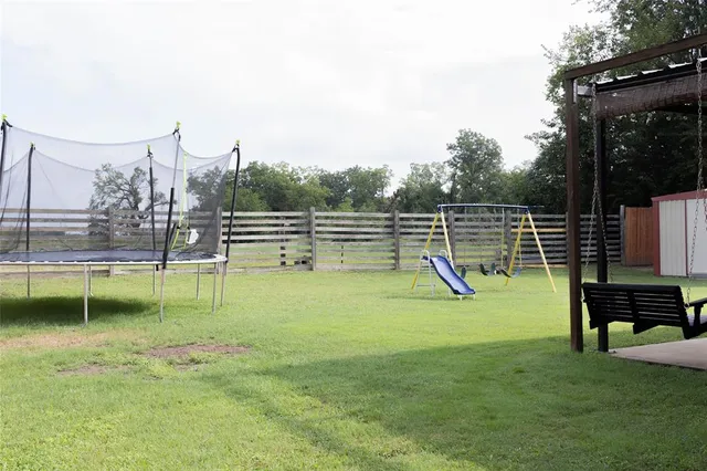 a view of a patio with table and chairs and potted plants