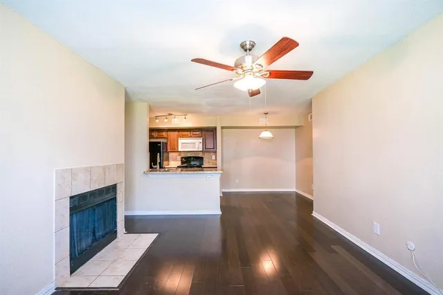 a view of a livingroom with wooden floor and a ceiling fan