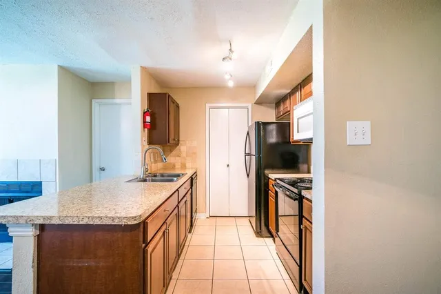 a kitchen with a sink stove and refrigerator