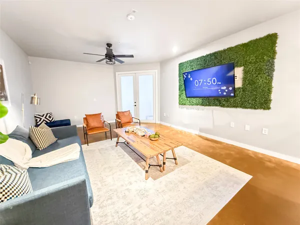 a living room with furniture and a flat screen tv