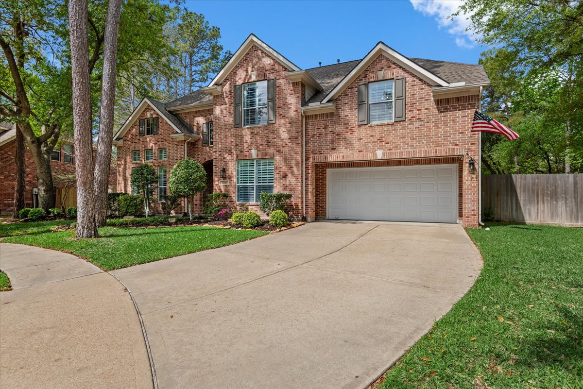 15519 Stallion Point Circle Cypress, TX 77429 - Photo 3 of 37 The property features a brick exterior with a multi-gabled roof and an attached two-car garage