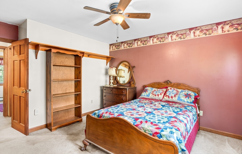 465 Doe Valley Road Athol, MA 01331 - Photo 11 of 36 a bedroom with a bed and a chandelier