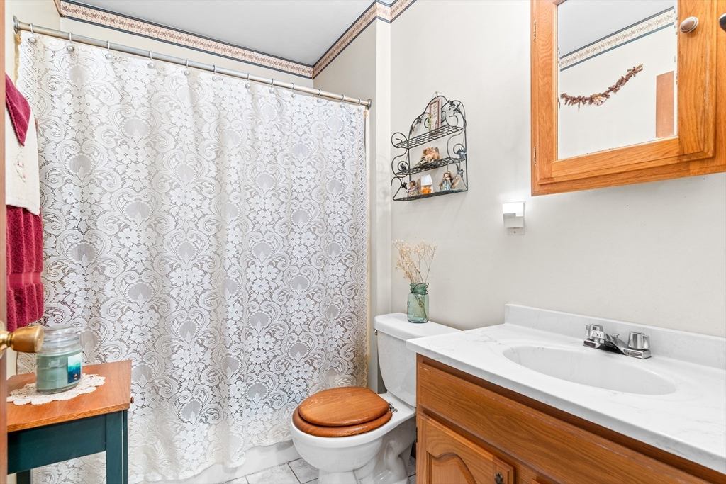 465 Doe Valley Road Athol, MA 01331 - Photo 17 of 36 a bathroom with a sink a toilet and a mirror