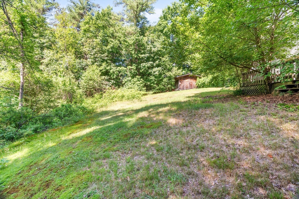 465 Doe Valley Road Athol, MA 01331 - Photo 30 of 36 a backyard of a house with a yard and large trees