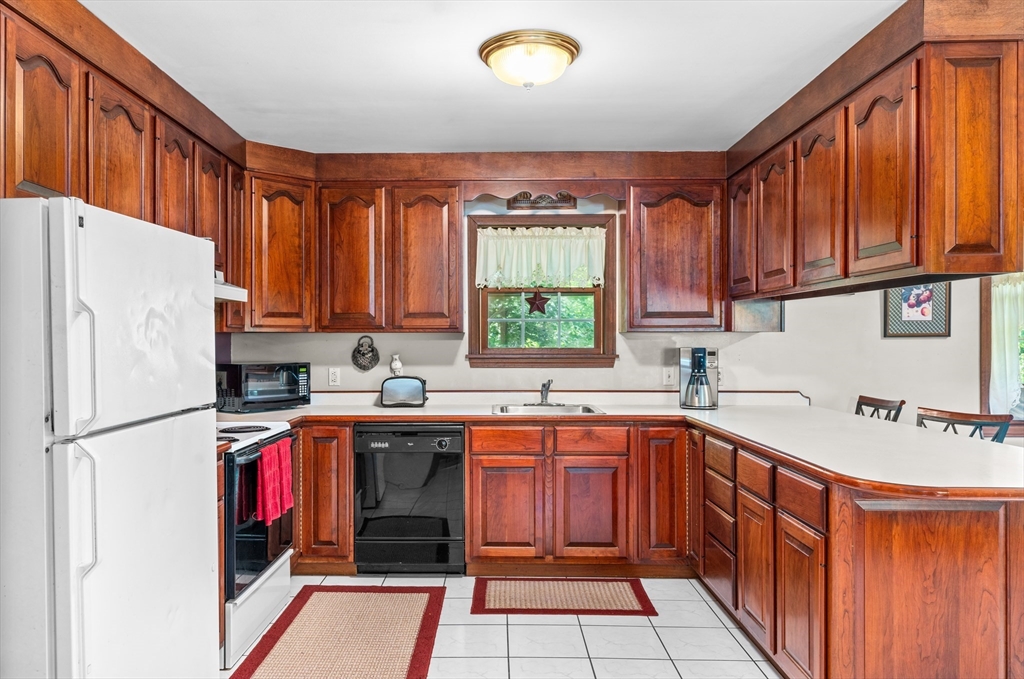 465 Doe Valley Road Athol, MA 01331 - Photo 4 of 36 a kitchen with stainless steel appliances granite countertop a sink stove refrigerator and cabinets