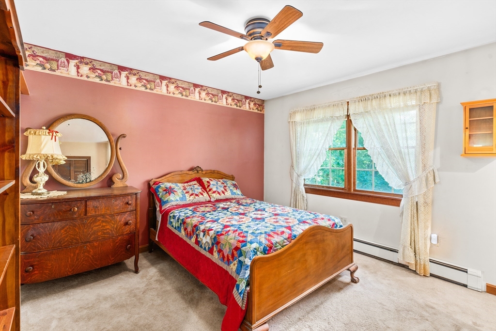 465 Doe Valley Road Athol, MA 01331 - Photo 9 of 36 a bedroom with a bed and a chandelier