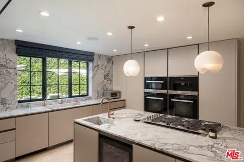 a kitchen with a refrigerator and a sink