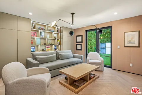 a living room with furniture a ceiling fan and a rug