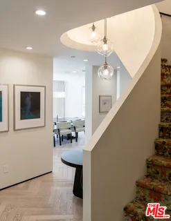 a dining room with furniture and chandelier
