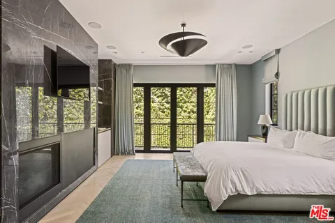 a bedroom with a large bed and a large window