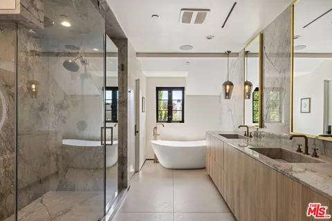 a bathroom with a granite countertop sink a toilet and shower