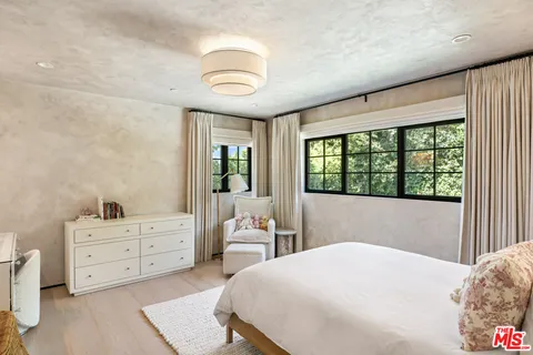 a bedroom with a large bed and a window