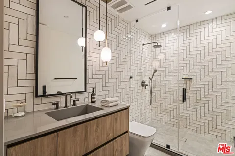 a bathroom with a granite countertop toilet sink and shower