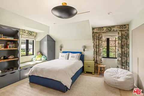 a bedroom with a bed and a chandelier