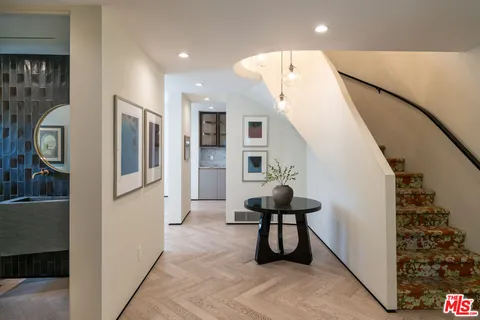 a view of entryway with furniture and front door