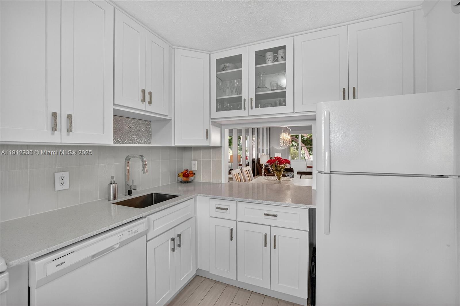 7817 Golf Cir Drive, Unit 305 Margate, FL 33063 - Photo 16 of 43 a kitchen with white cabinets and white appliances