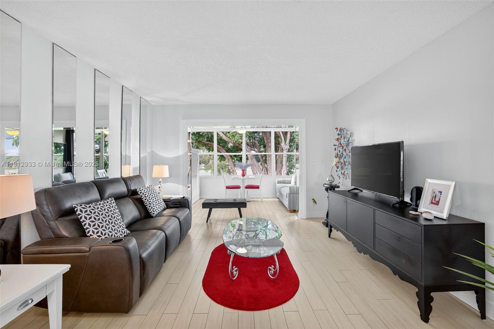 7817 Golf Cir Drive, Unit 305 Margate, FL 33063 - Photo 3 of 43 a living room with furniture and a flat screen tv
