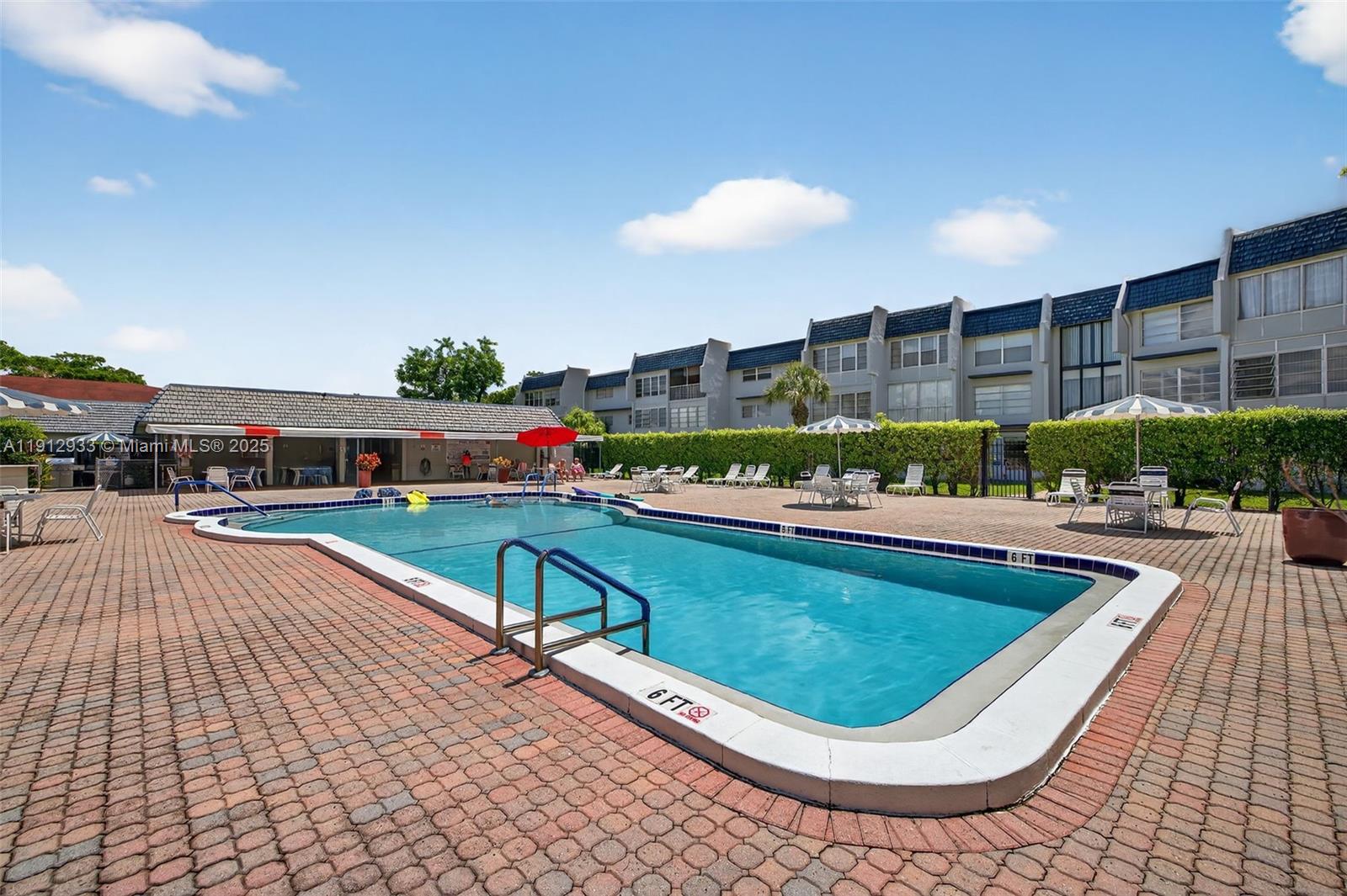 7817 Golf Cir Drive, Unit 305 Margate, FL 33063 - Photo 34 of 43 a swimming pool with outdoor seating and yard
