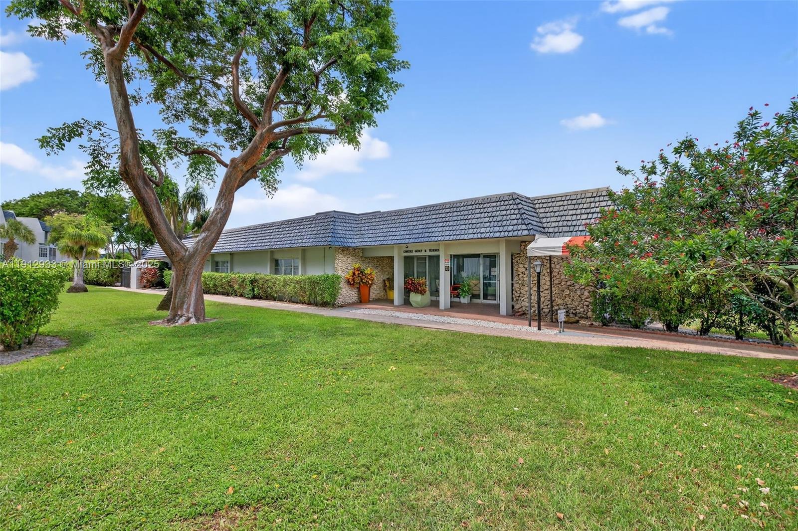 7817 Golf Cir Drive, Unit 305 Margate, FL 33063 - Photo 36 of 43 a front view of a house with garden