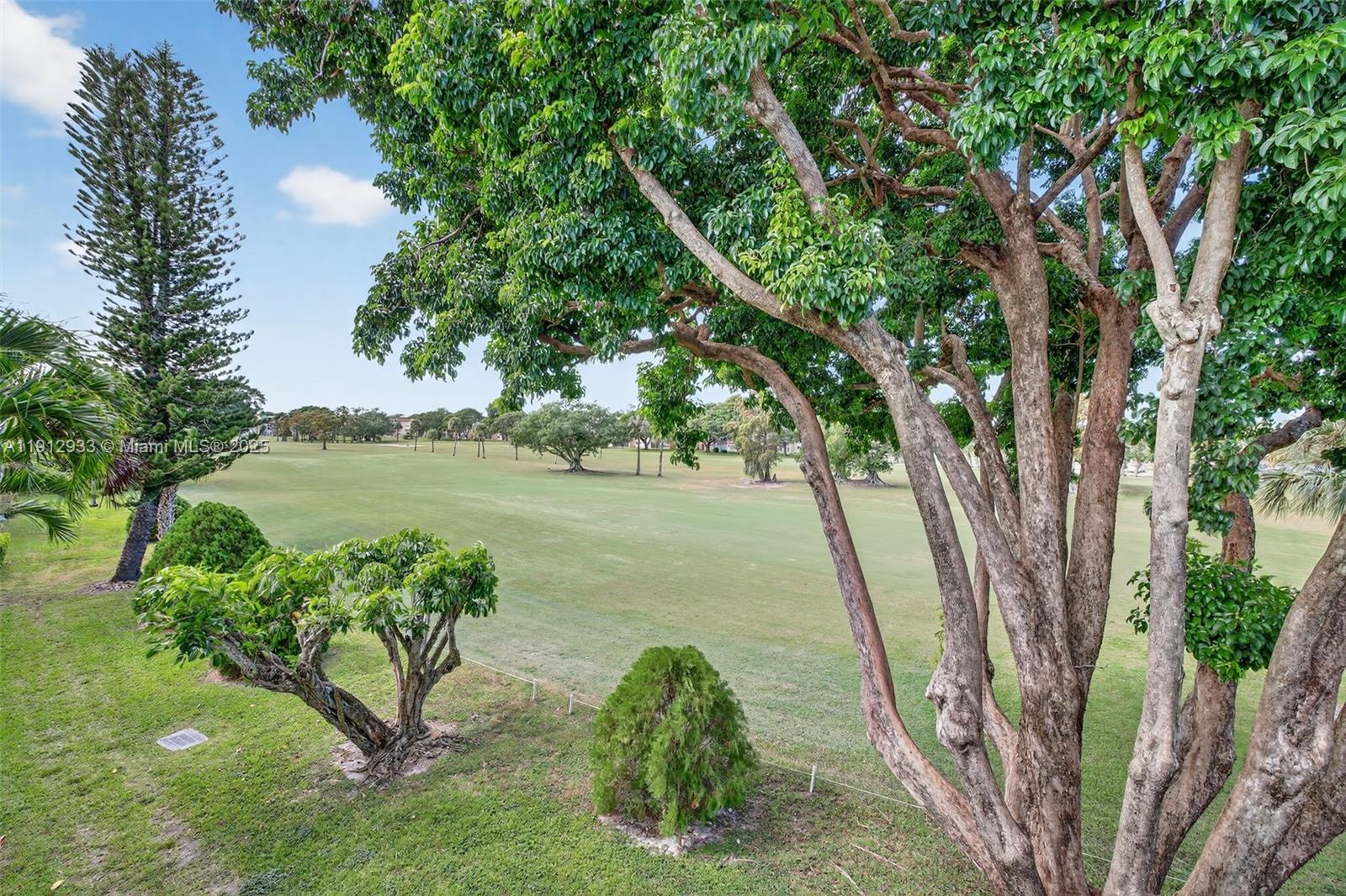 7817 Golf Cir Drive, Unit 305 Margate, FL 33063 - Photo 7 of 43 a backyard of a house with lots of green space and lake view