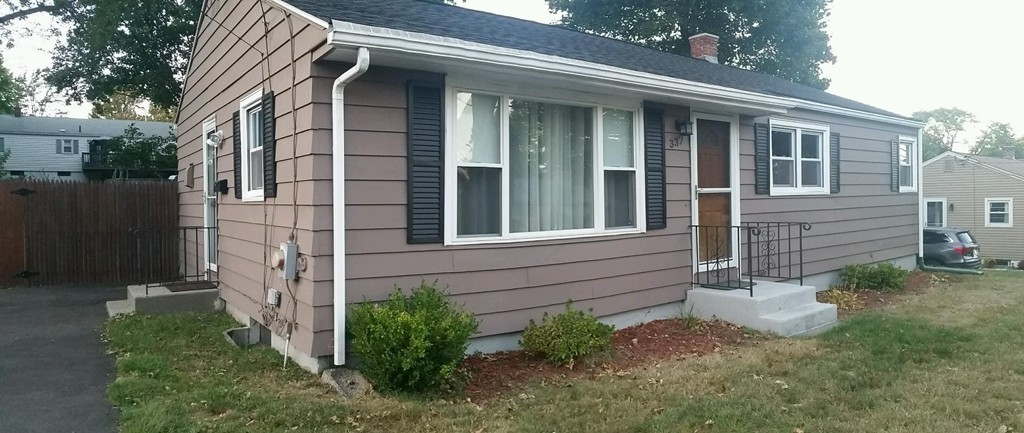 337 Westfield Road Holyoke, MA 01040 - Photo 13 of 13 a view of a house with brick walls and a yard