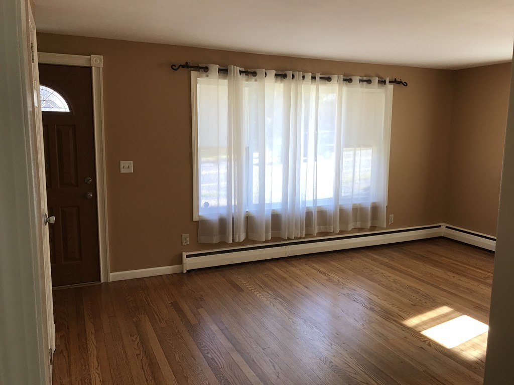 337 Westfield Road Holyoke, MA 01040 - Photo 5 of 13 an empty room with wooden floor and windows