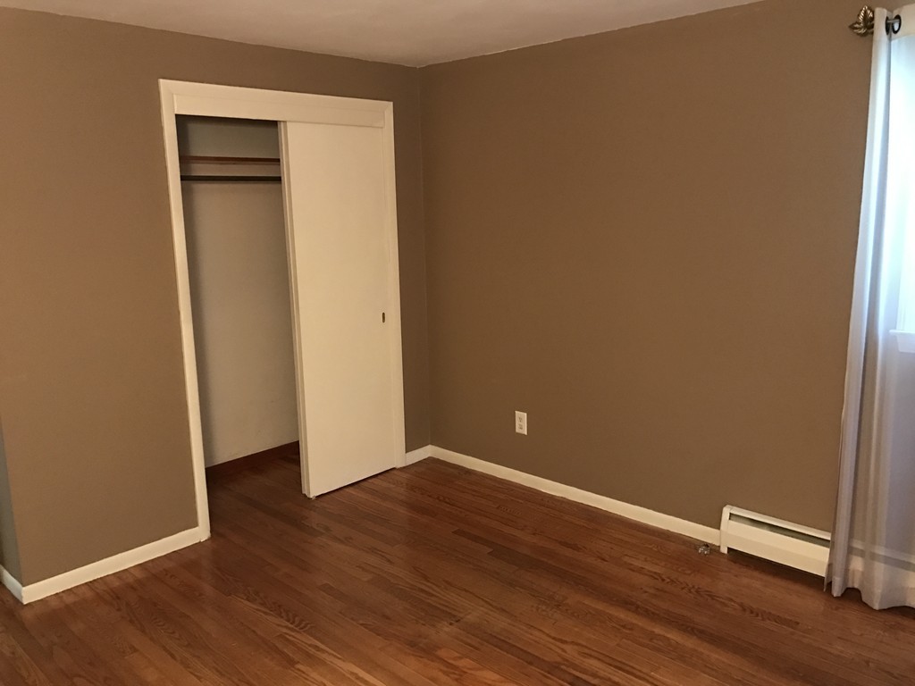 337 Westfield Road Holyoke, MA 01040 - Photo 7 of 13 an empty room with wooden floor and closet